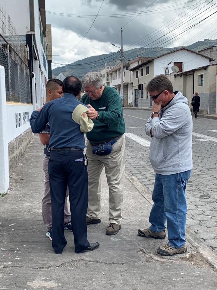 Abide in Christ evangelism team praying with a new believer in Jesus Christ.