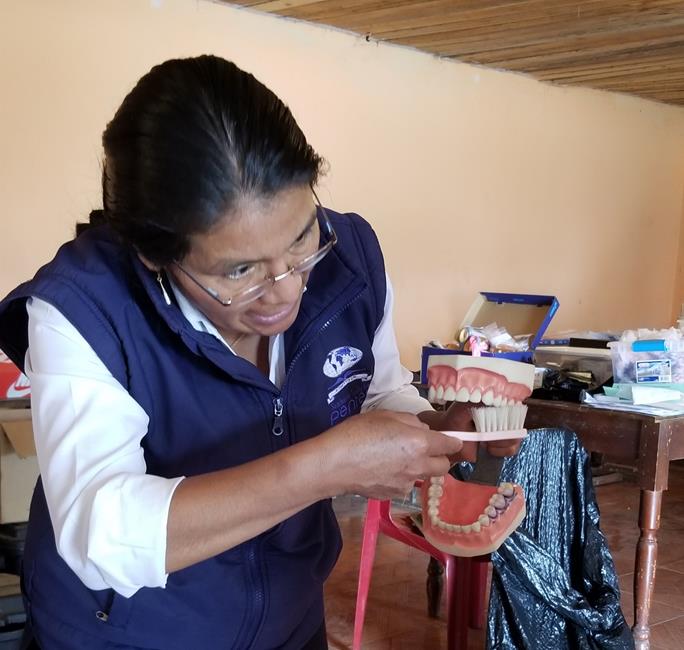 Ecuadorian nurse teaching dental hygiene on Abide in Christ team.