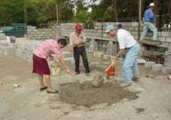 Zulema mixing concrete with Lee at Zapotillo