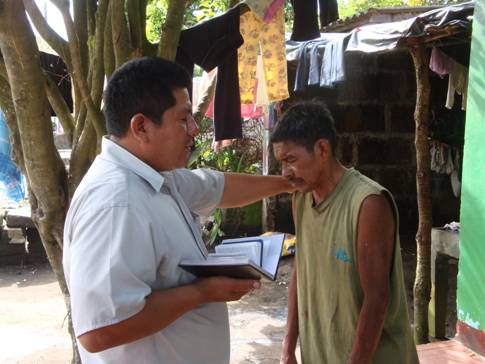 Pastor praying with new believer in Nicaragua.