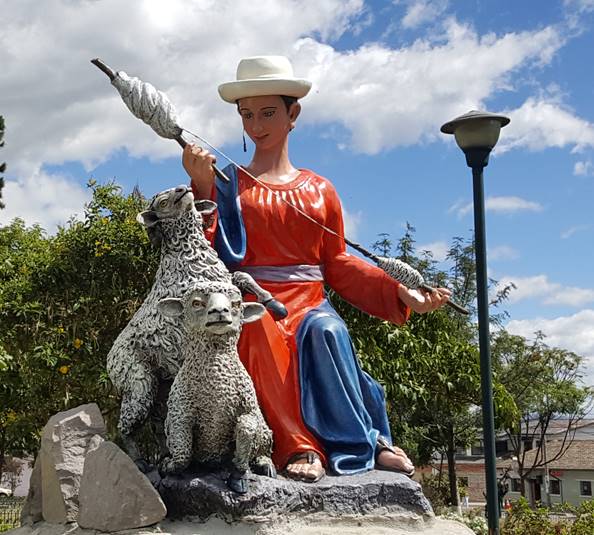 Pifo, Ecuador park artistic statue of woman and sheep.