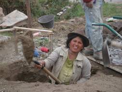 Quechua indian woman constructing new mission church