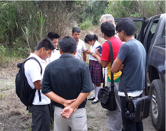Shuar teens recording decisions in their New Testaments.