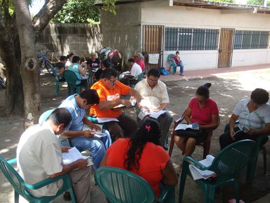 Small groups studying at evangelism workshop.
